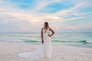 beautiful bride posing on the beach on her wedding day at sunset on Panama City Beach Florida