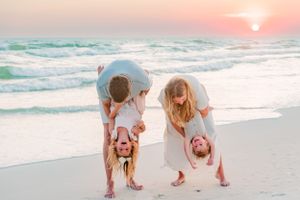 Fun family of four playing with their kids on Panama City Beach Florida