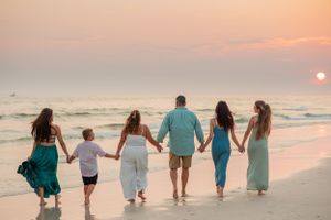 beautiful family of 6 walking at sunset on Panama City Beach Florida