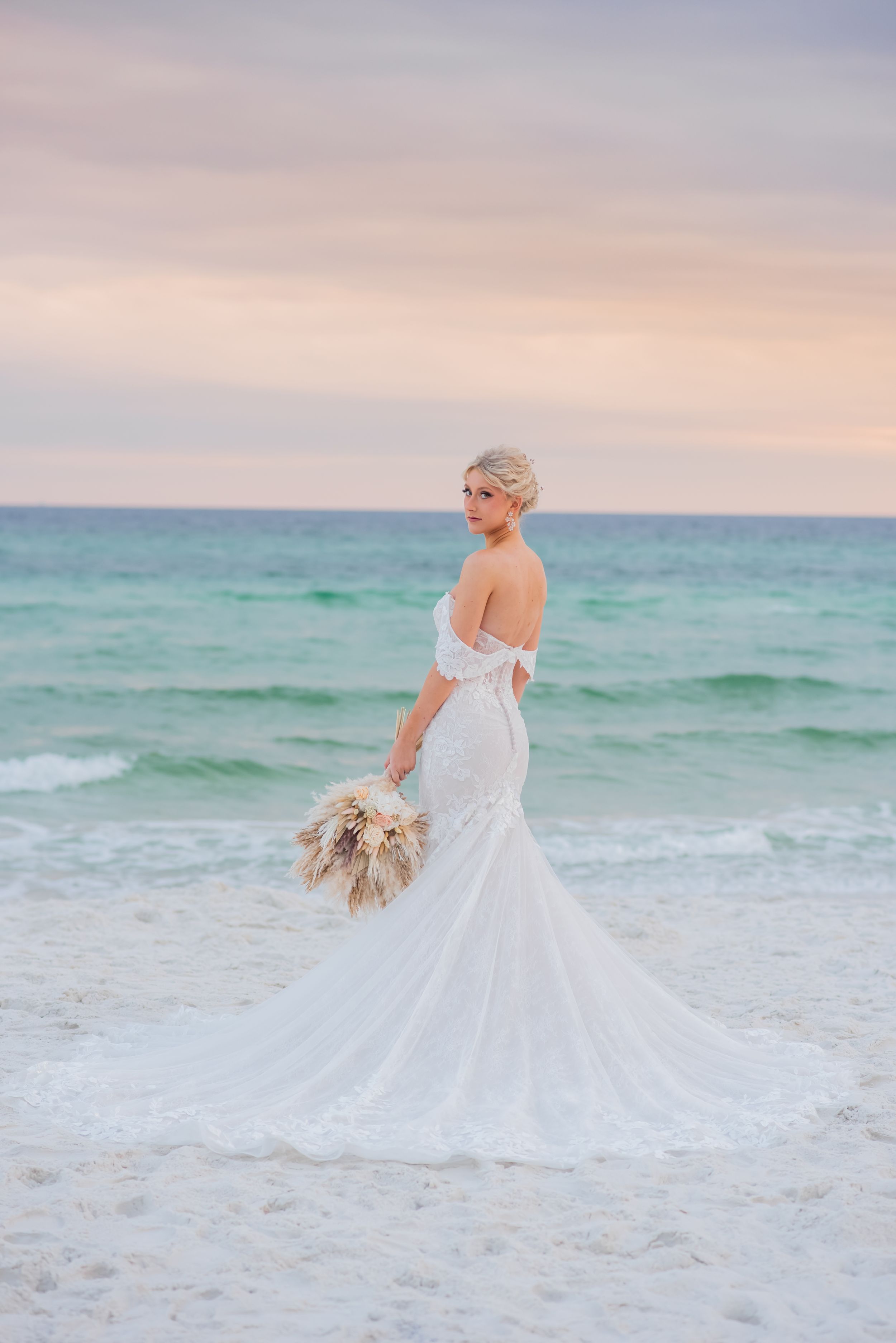bride posing on beach after beach wedding on Panama City Beach Florida at sunset