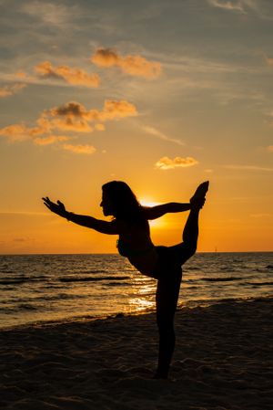 woman in a yoga pose at sunset on Panama City Beach Florida
