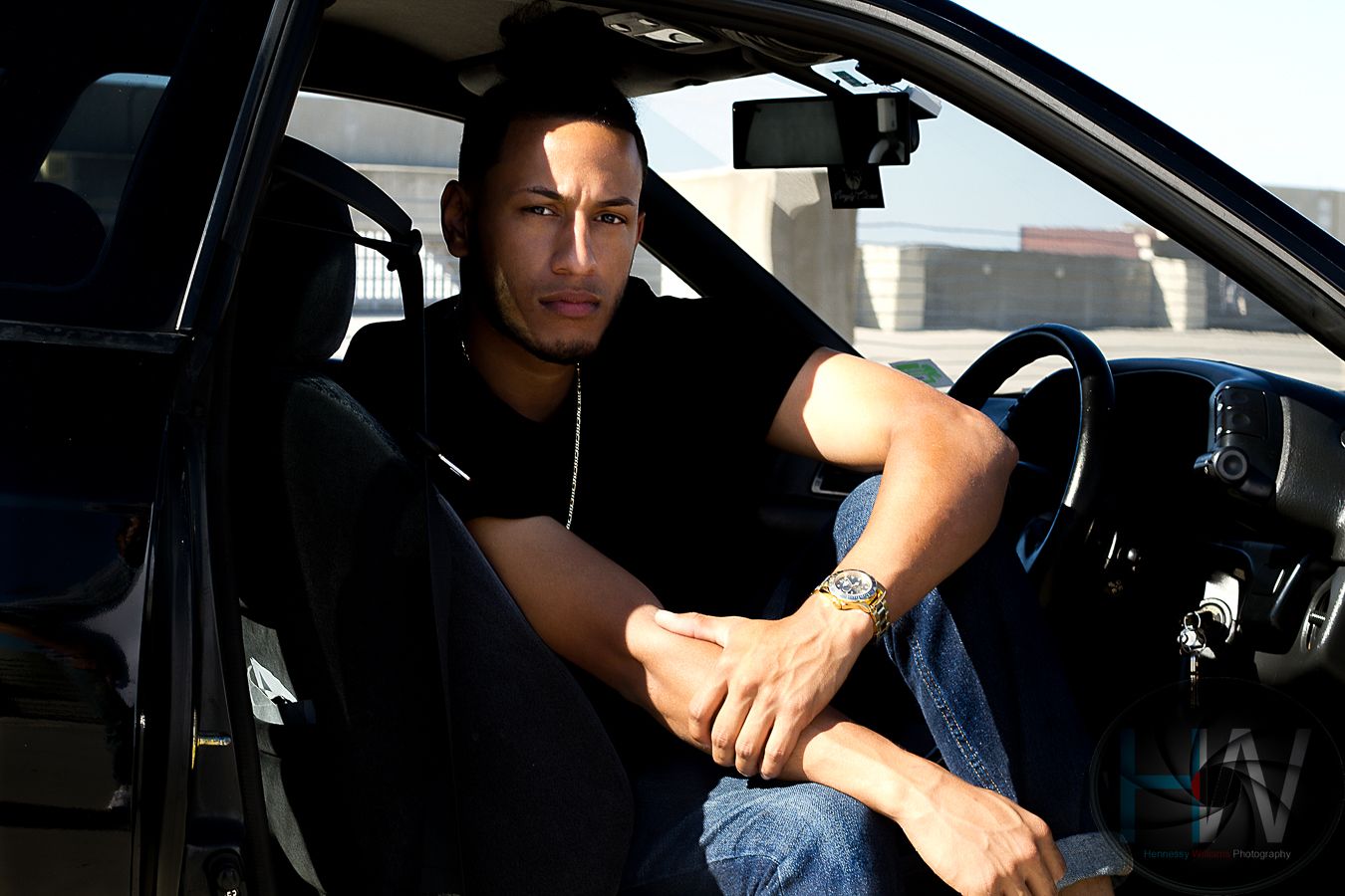 Interior car portrait showing person sitting in driver's seat of vehicle.