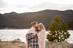 Romantic couple photos at sunset by a mountain lake.