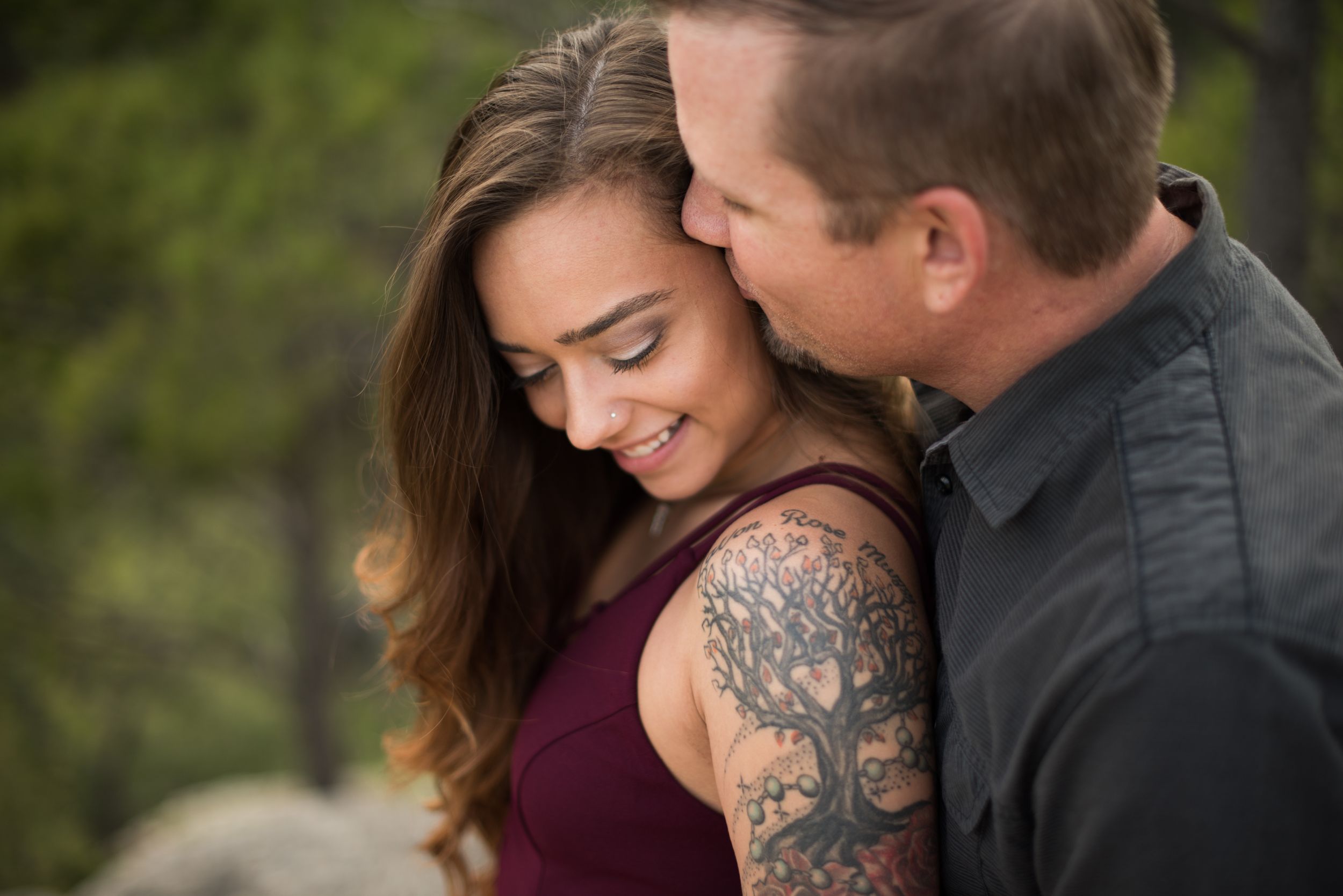 Romantic couple embracing in a natural outdoor setting.
