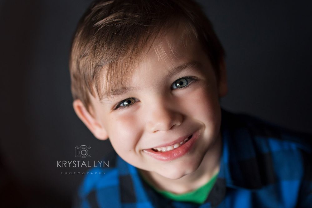 Happy child taking close up photograph wearing blue and black