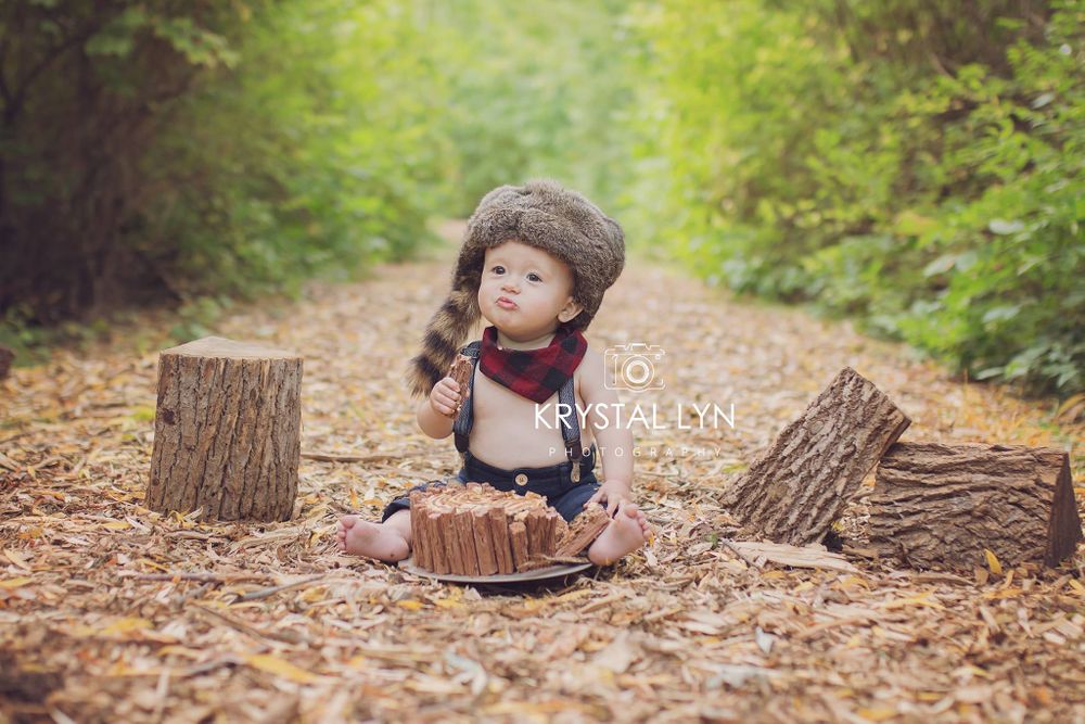 Celebrating his first birthday with photographs on a woodchip path in Milton