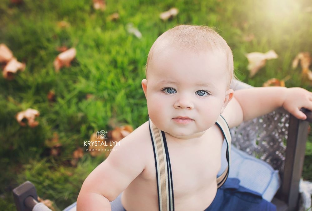 Outdoor sitter session for this little boy in his suspenders