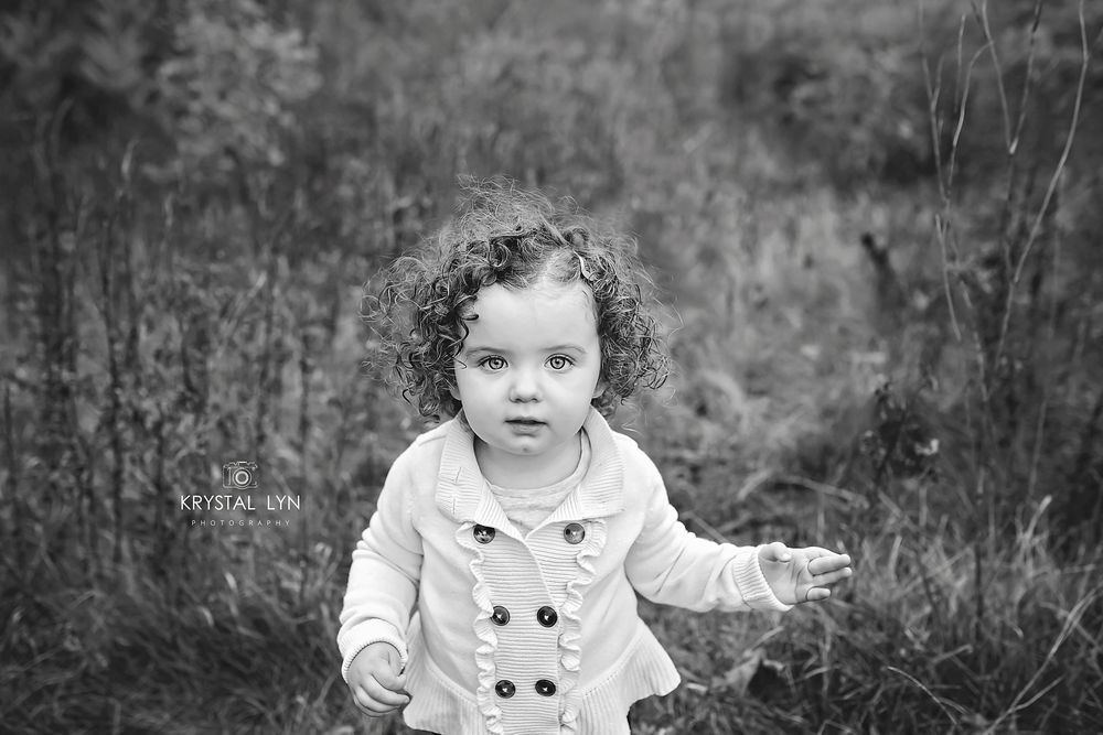 Black and white portrait of cute curly haired child
