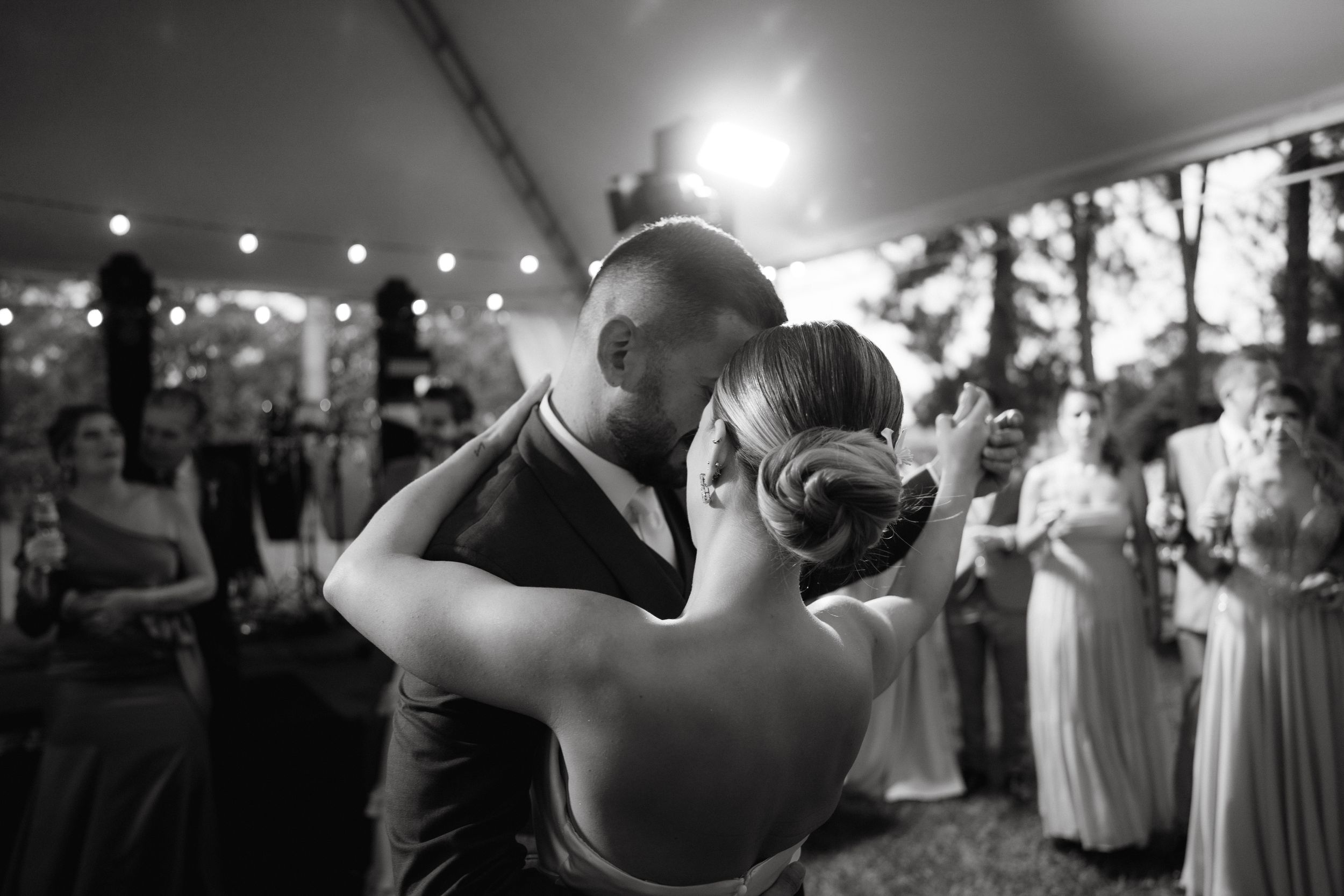 Black and white capture of a couple's intimate dance moment at their wedding reception.
