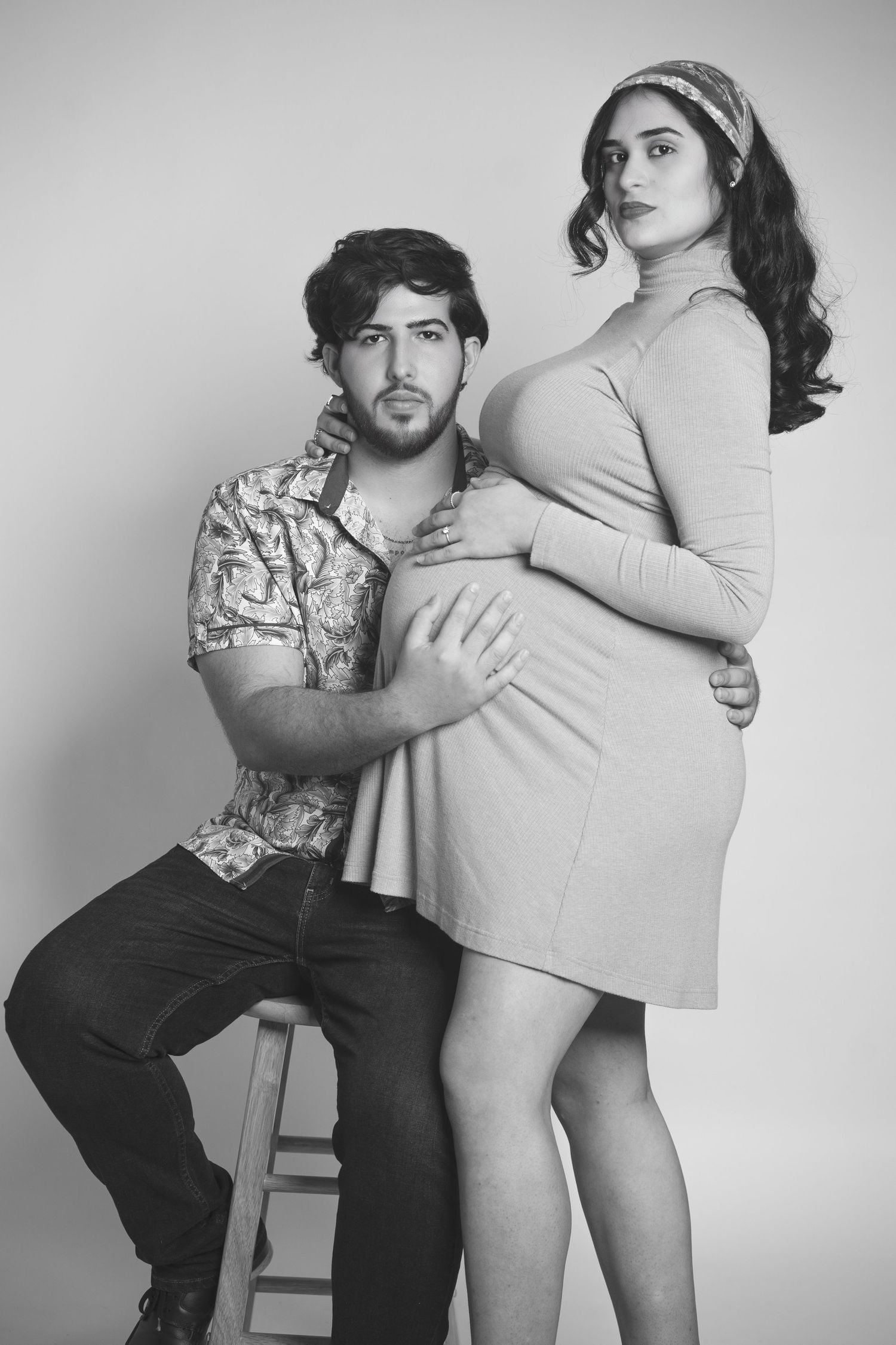 Black and white maternity portrait of couple in vintage inspired styling.