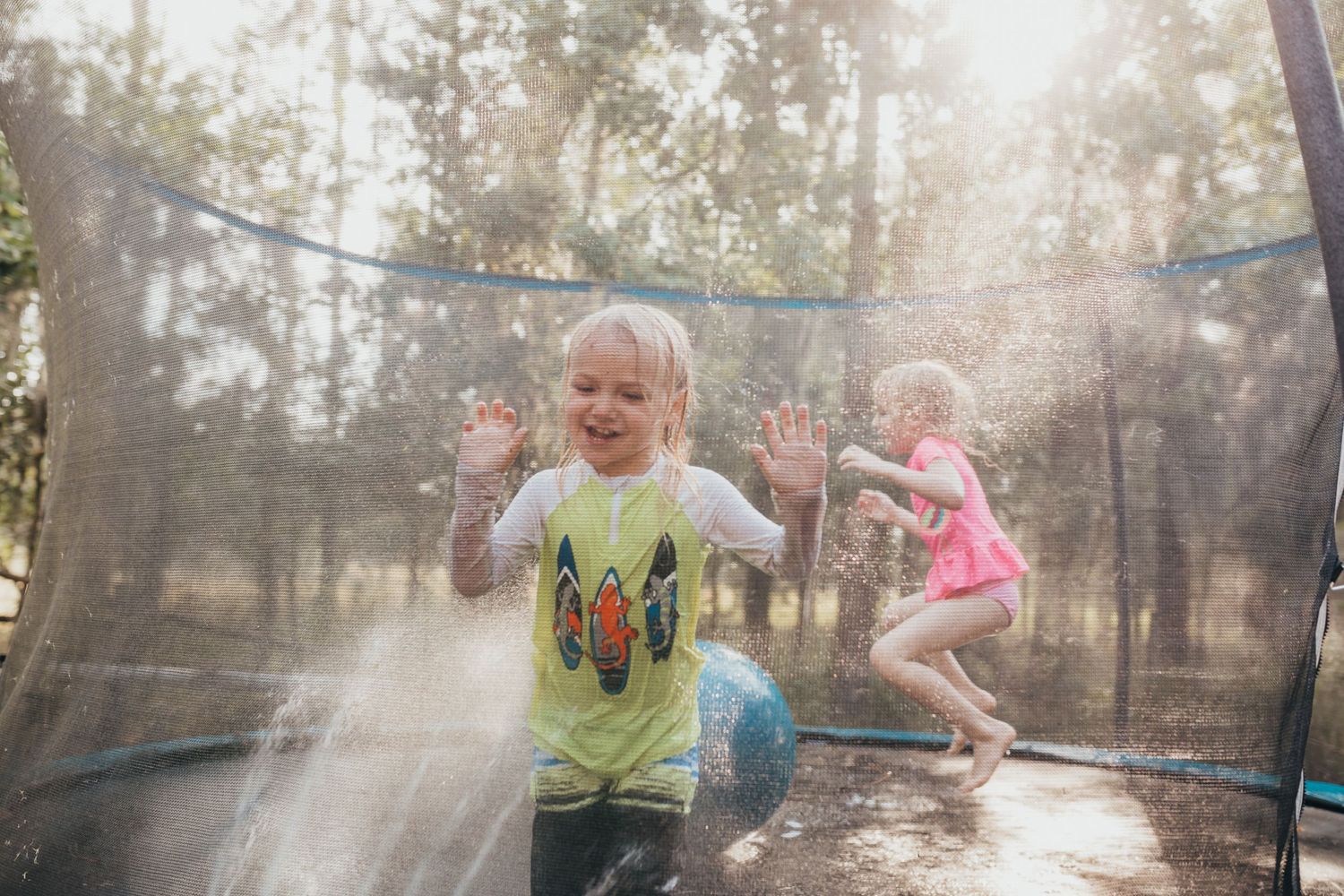 Lakeland Family photographer- Little boy and girl on trampoline