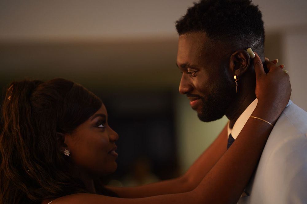 A romantic moment captured between two people in formal attire during an intimate dance.