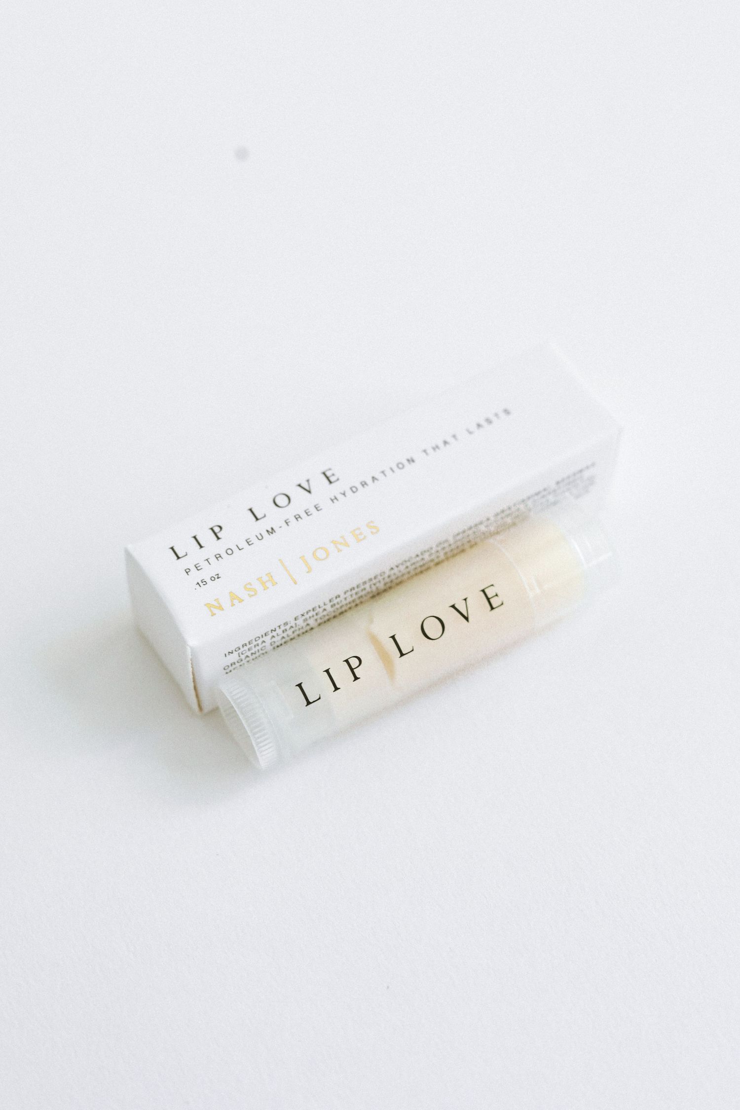 White lip care product packaging labeled 'Lip Love' on white background.