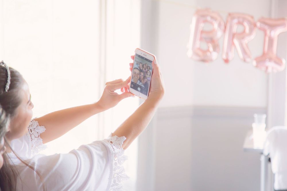 Bride taking a selfie with bridesmaids