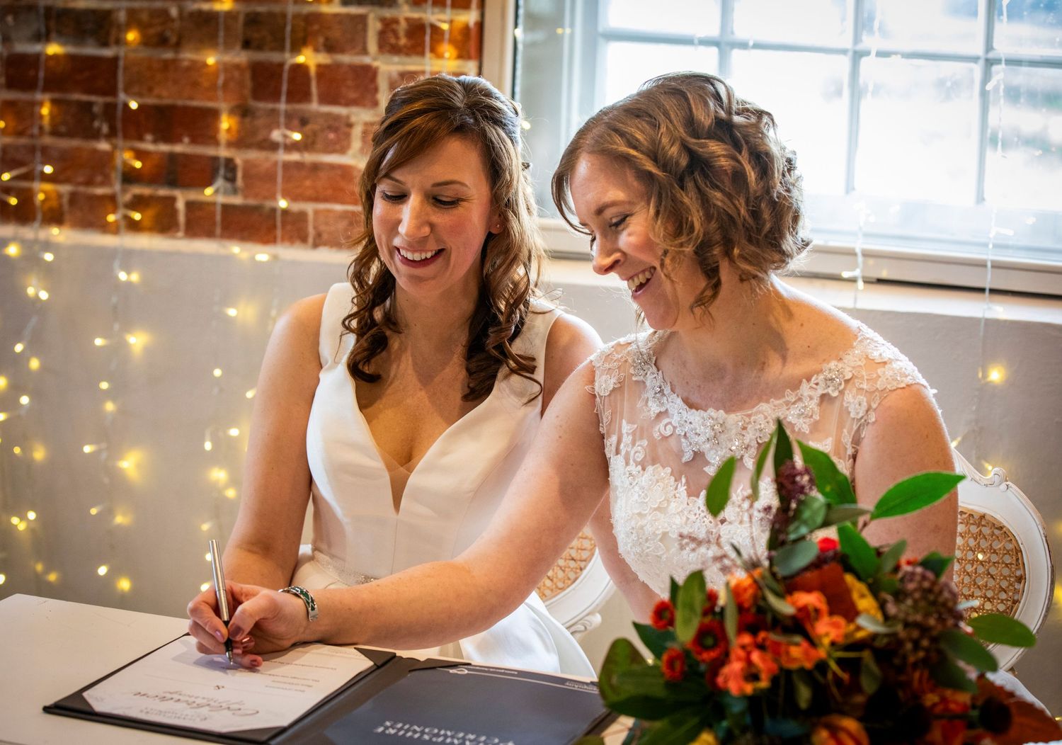 Wedding ceremony in industrial style venue with exposed brick and natural lighting.