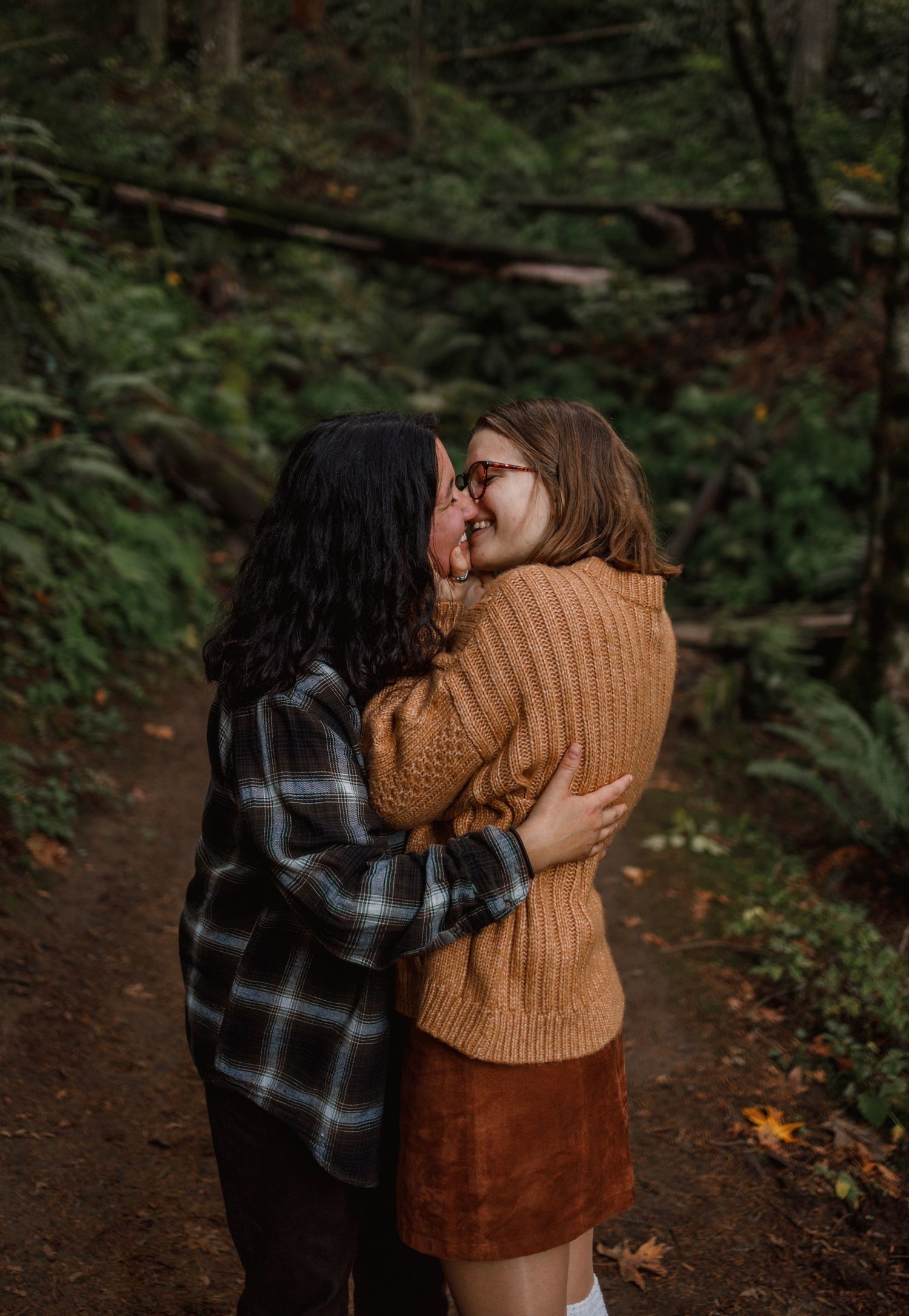 young couple embraces in forest park, portland, oregon