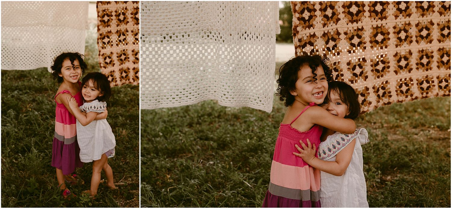 Side-by-side photos of two children hugging in front of hanging textiles.