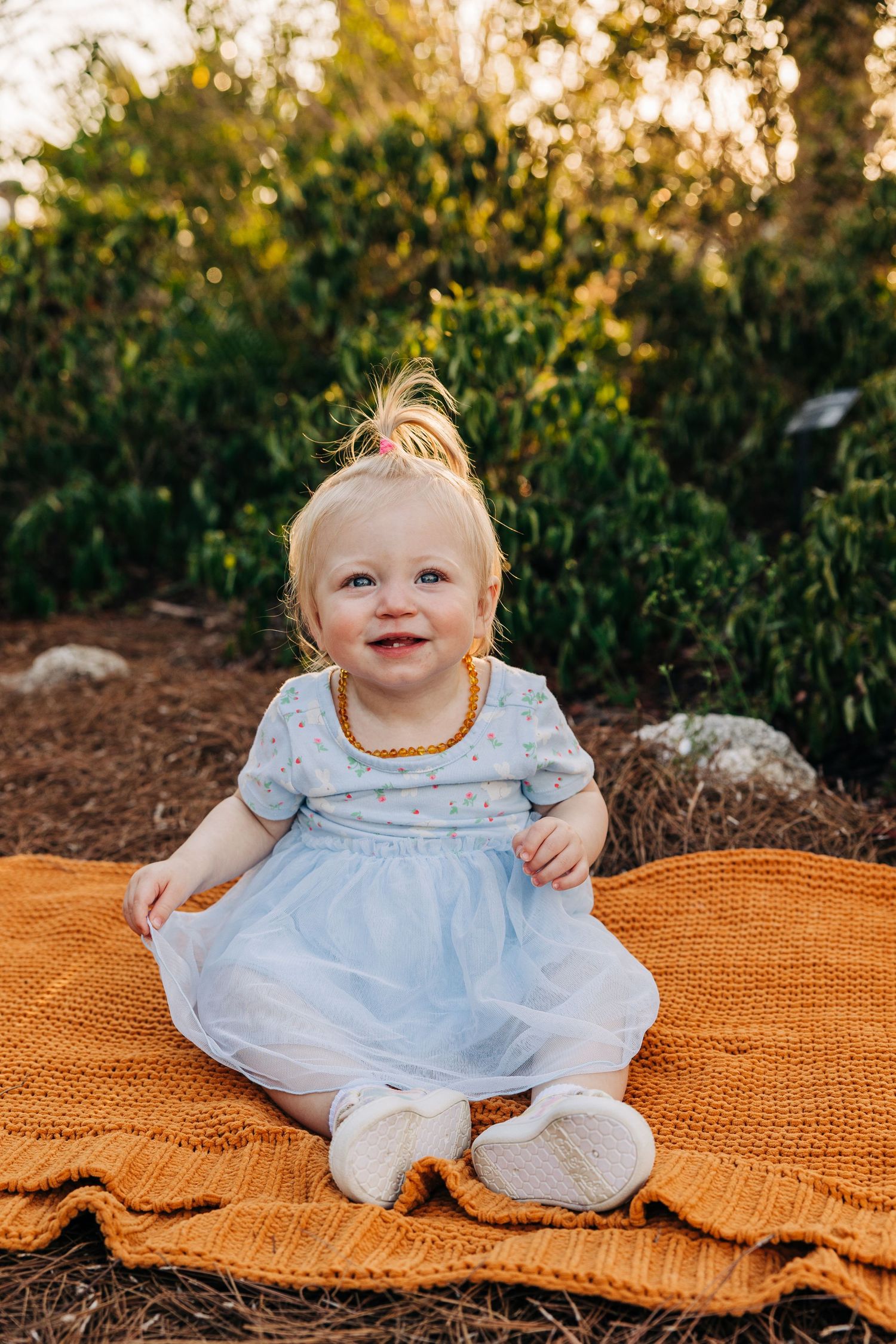 Baby girl sits on blanket at Celery Fields at sunset Sarasota family photographer Samantha Brown Artistry.