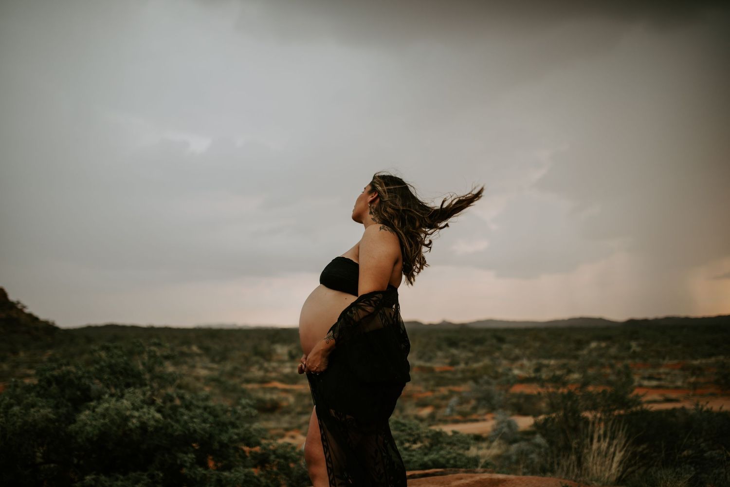 Pregnant woman with hair blowing in the wind