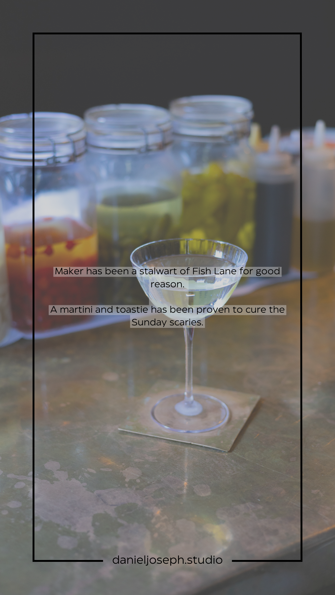 Martini glass with text overlay in front of mason jars filled with colored liquids.