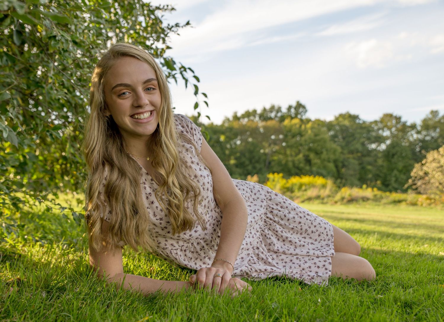 outdoor portrait of teenage girl in a tree lined field Loudon NH. white dress blond hair