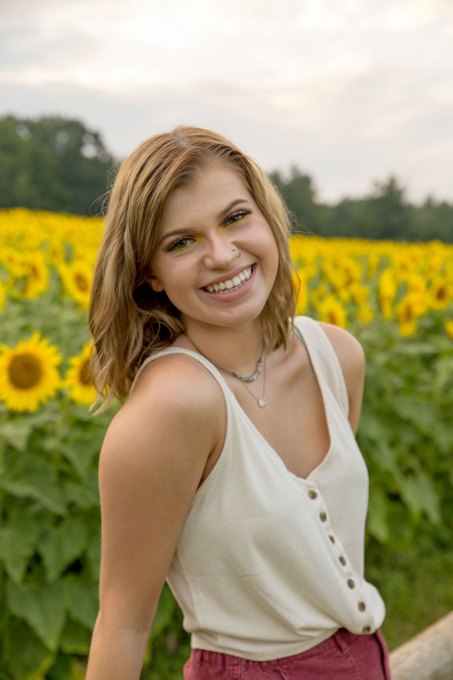 Senior HS. girl at Coppal house farm sunflower festival, lee nh for senior photos white tank top.