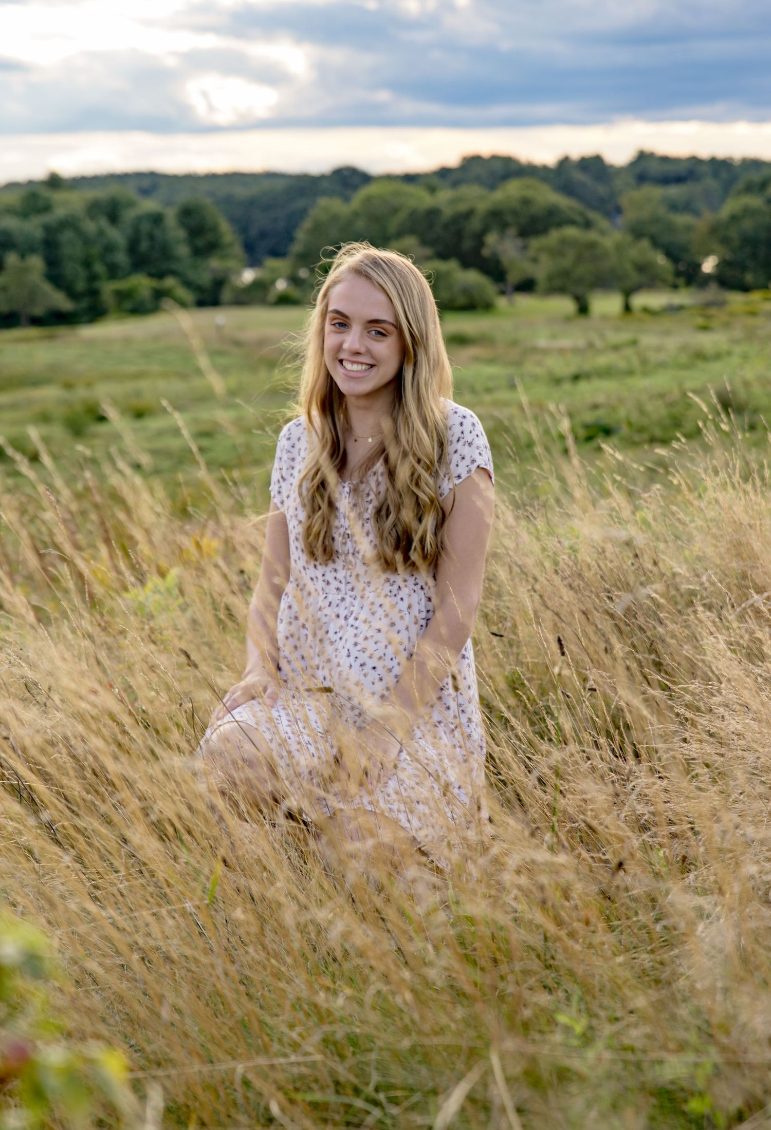outdoor portrait of teenage girl in a tree lined field Loudon NH. white dress blond hair