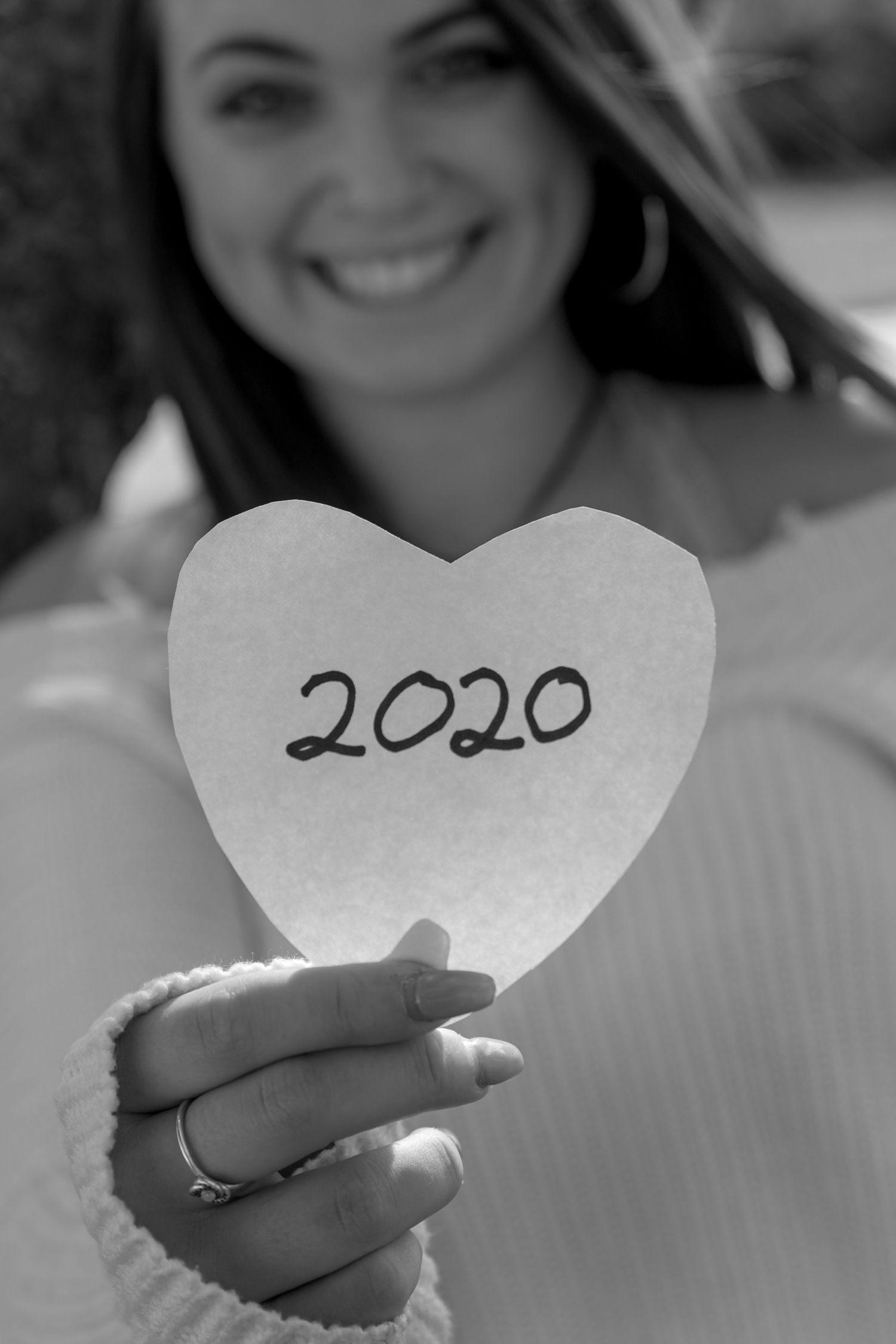 girl from class of 2020 holding a paper heart with the year on it. pittsfield nh