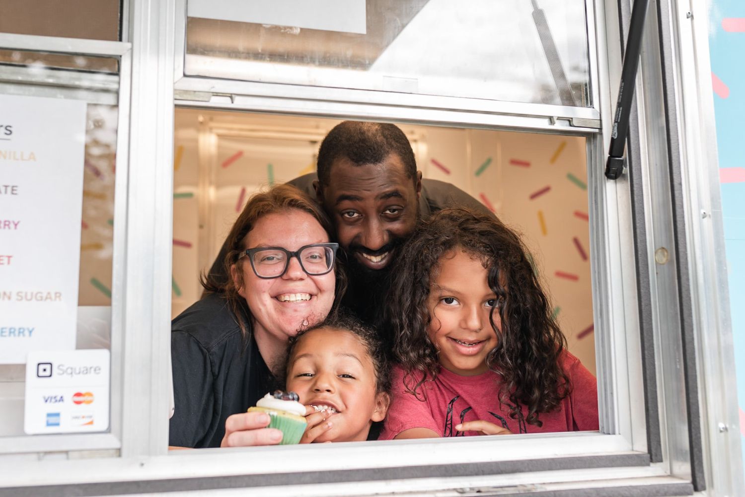 Family smiling from curbside cakery food truck in summerfield, nc