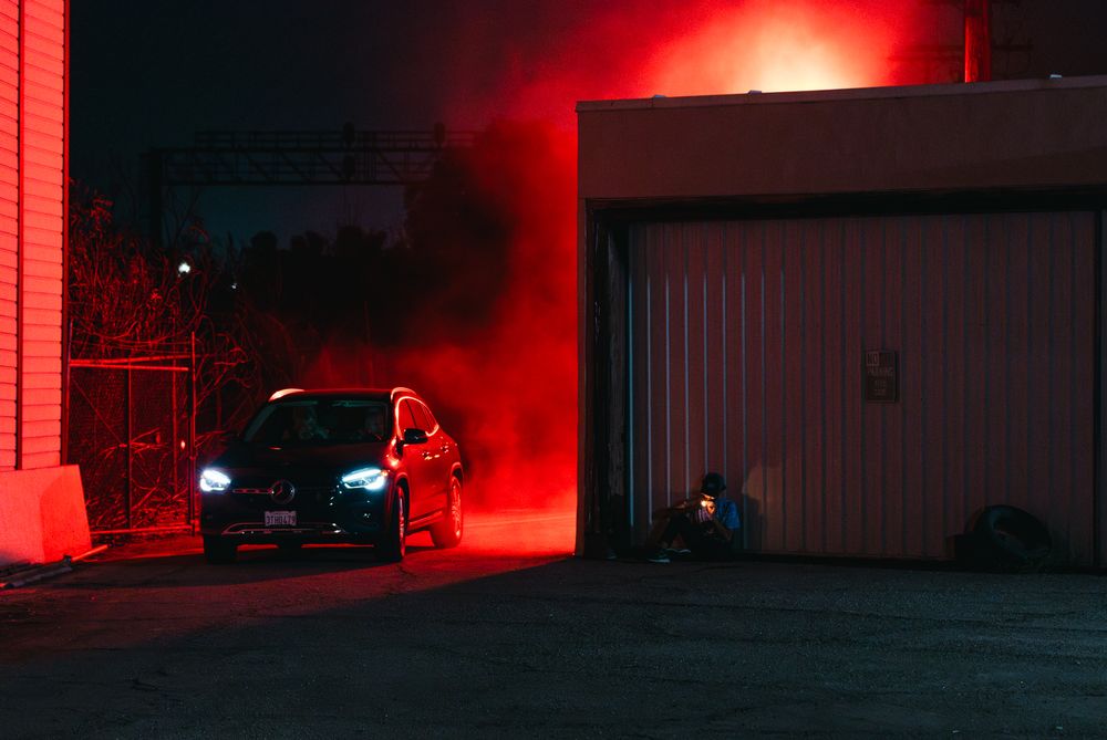 Building exterior illuminated by bright red lighting creating an eerie atmosphere.