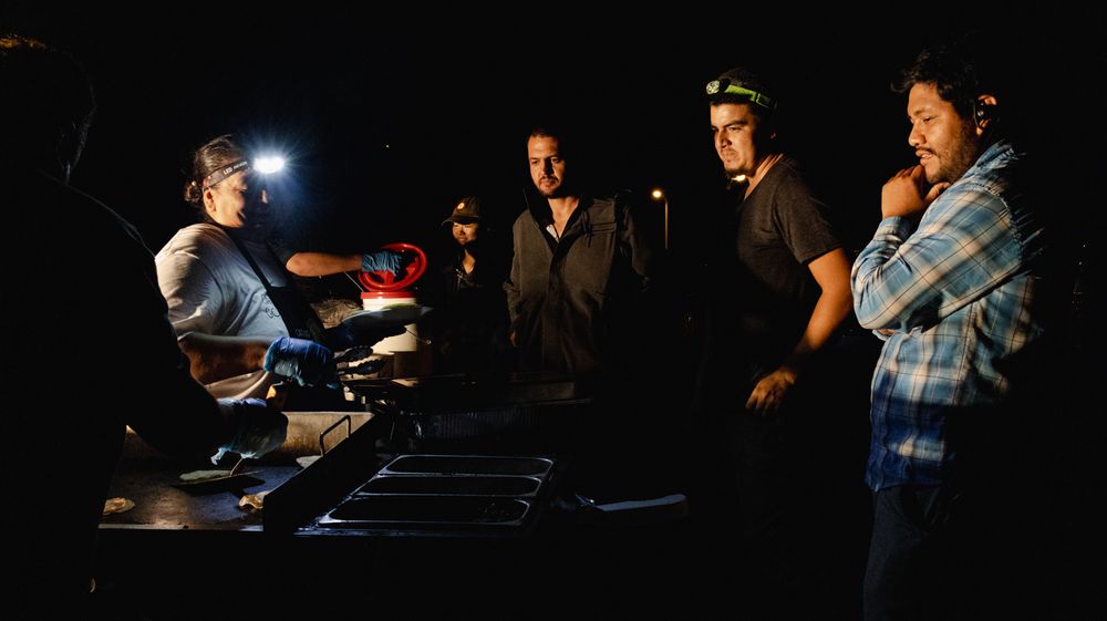 Dark room photography session with dramatic lighting effects and camera equipment.