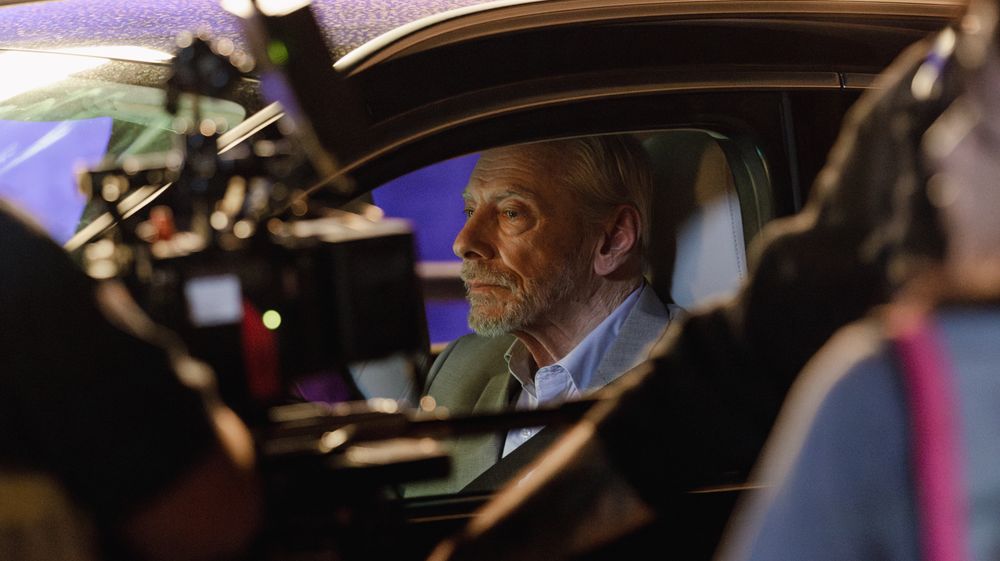 Interior view of a vehicle at night illuminated by emergency lights.