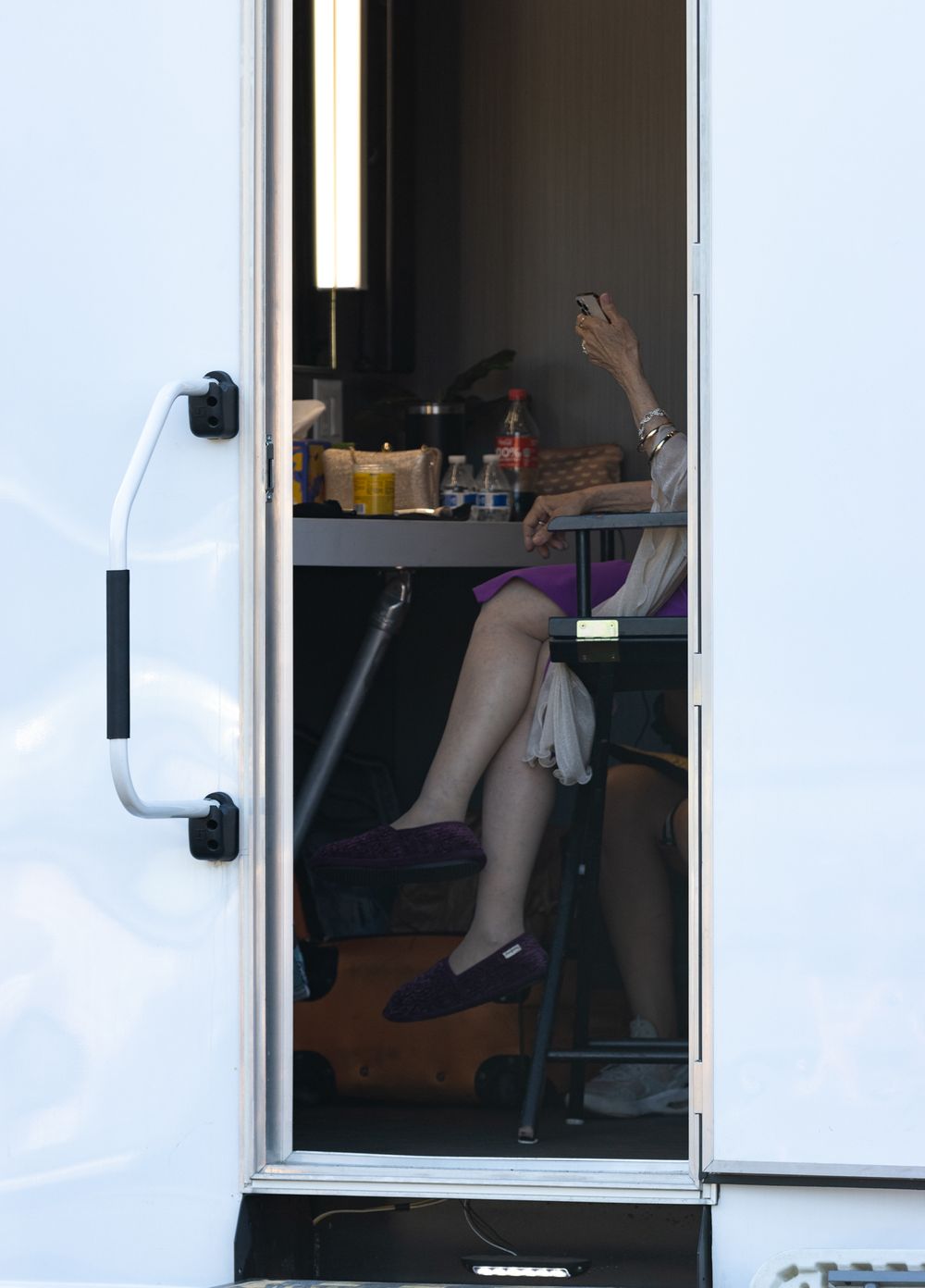 View through a white door window showing interior of a mobile unit or trailer.