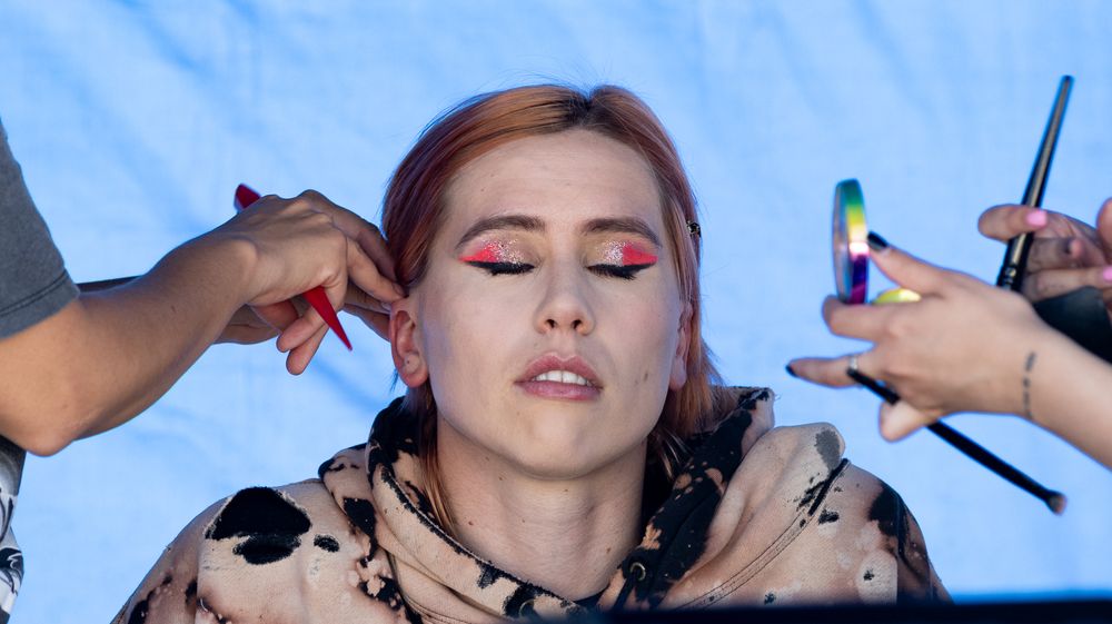 Makeup artists working on models during a beauty preparation session.
