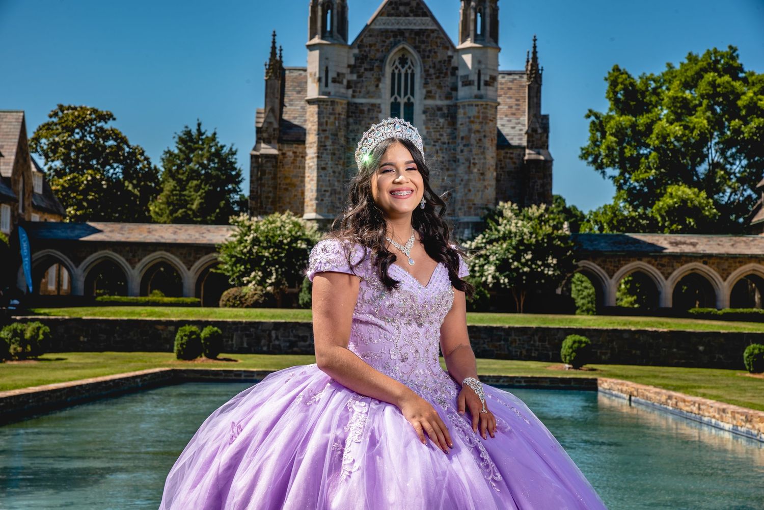 A lavender ballgown dress photographed in front of a grand stone cathedral building.