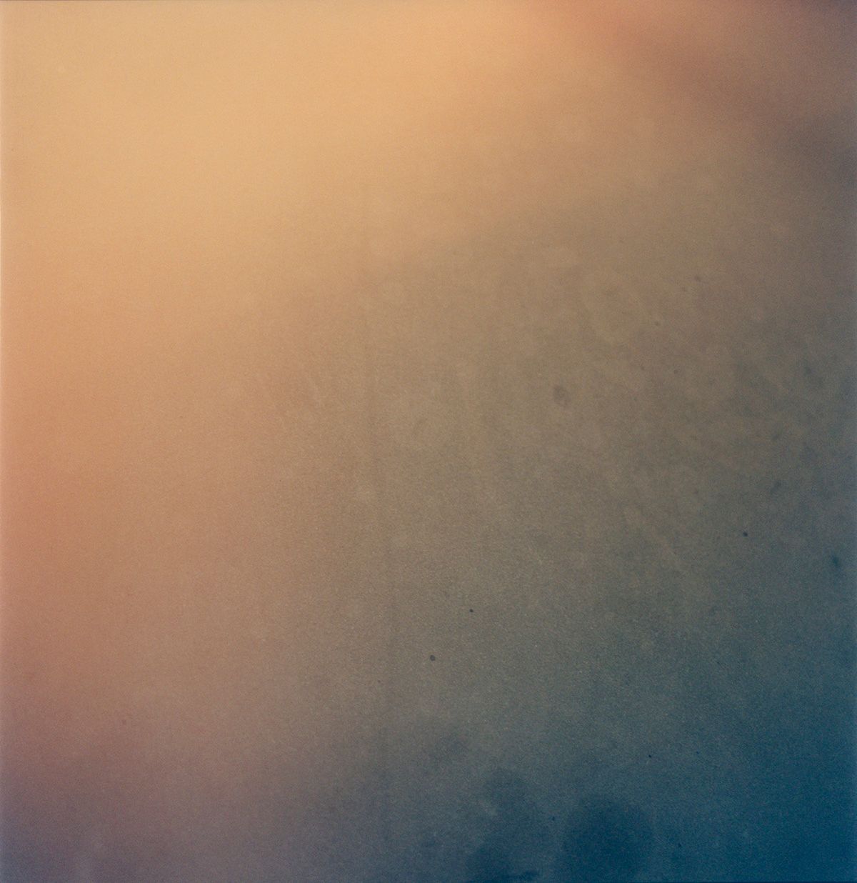 Warm peach tones blending into cool blue creating a soft atmospheric gradient.