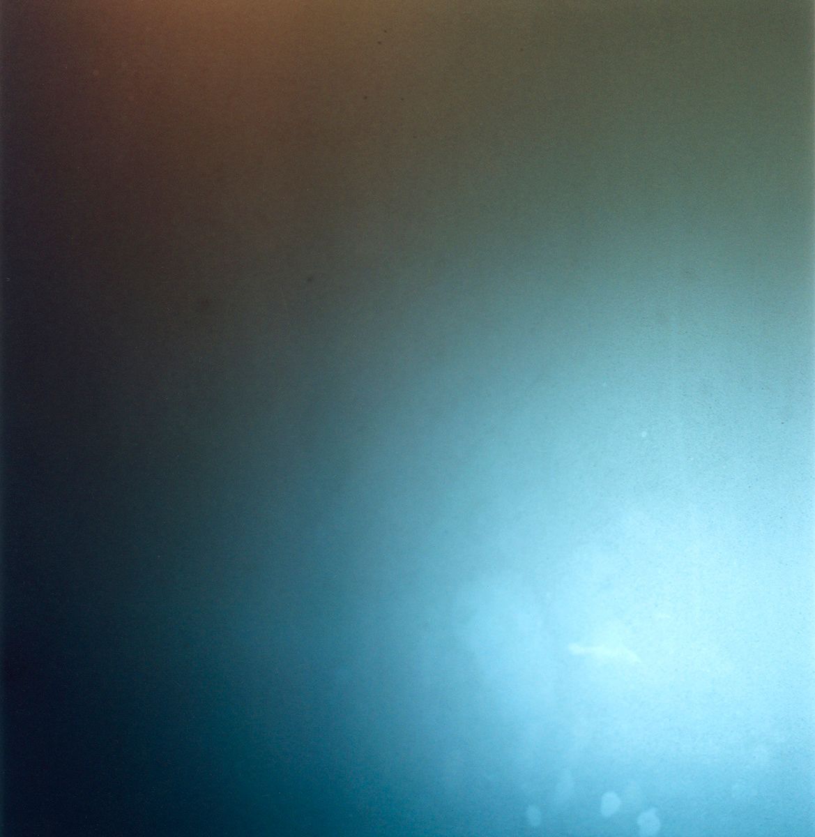 Ethereal gradient transitioning from deep brown to luminous turquoise blue.