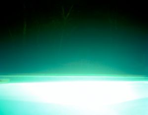 Abstract turquoise and white gradient background with bright horizontal light streaks.