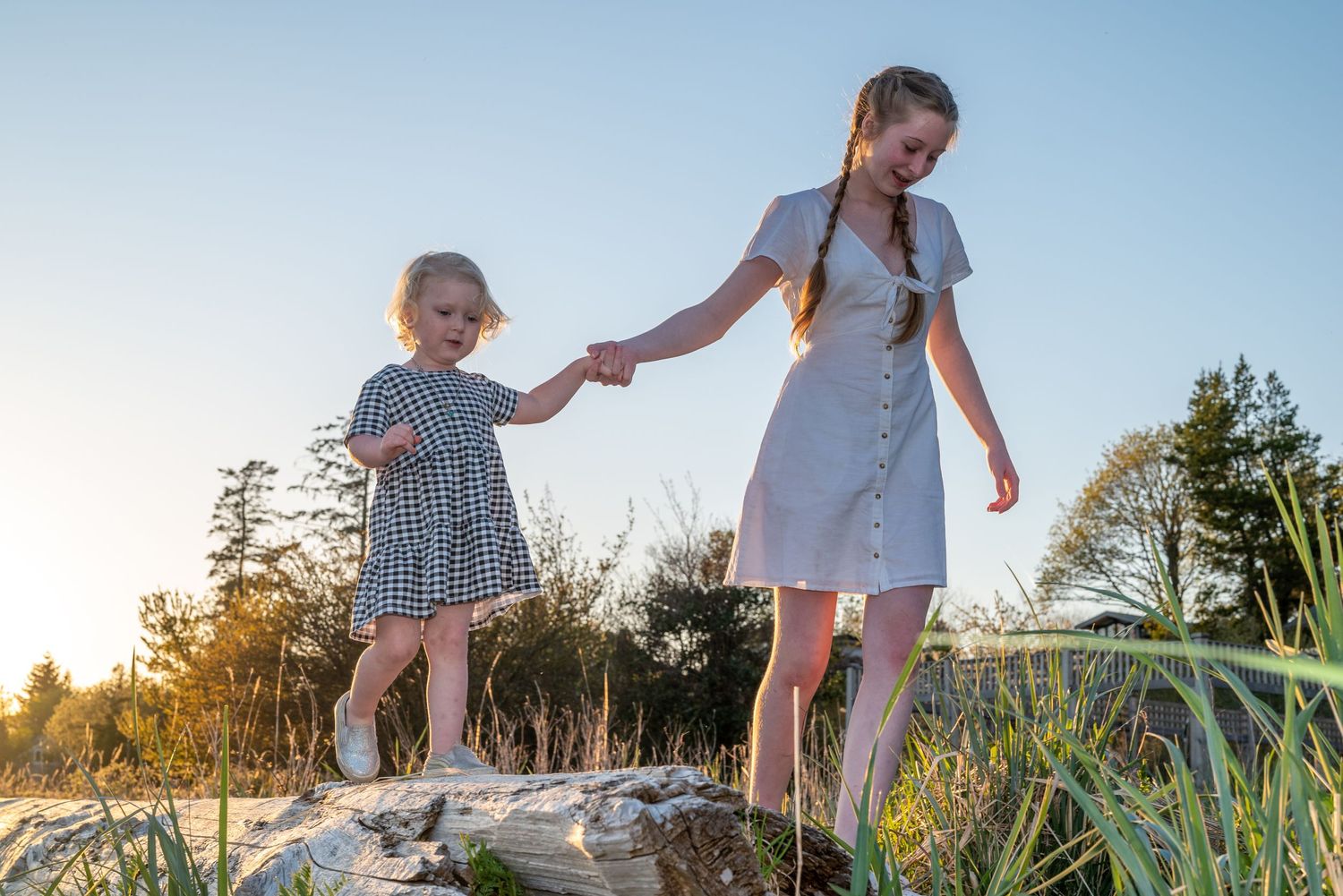 Little girl holds her sisters hand
