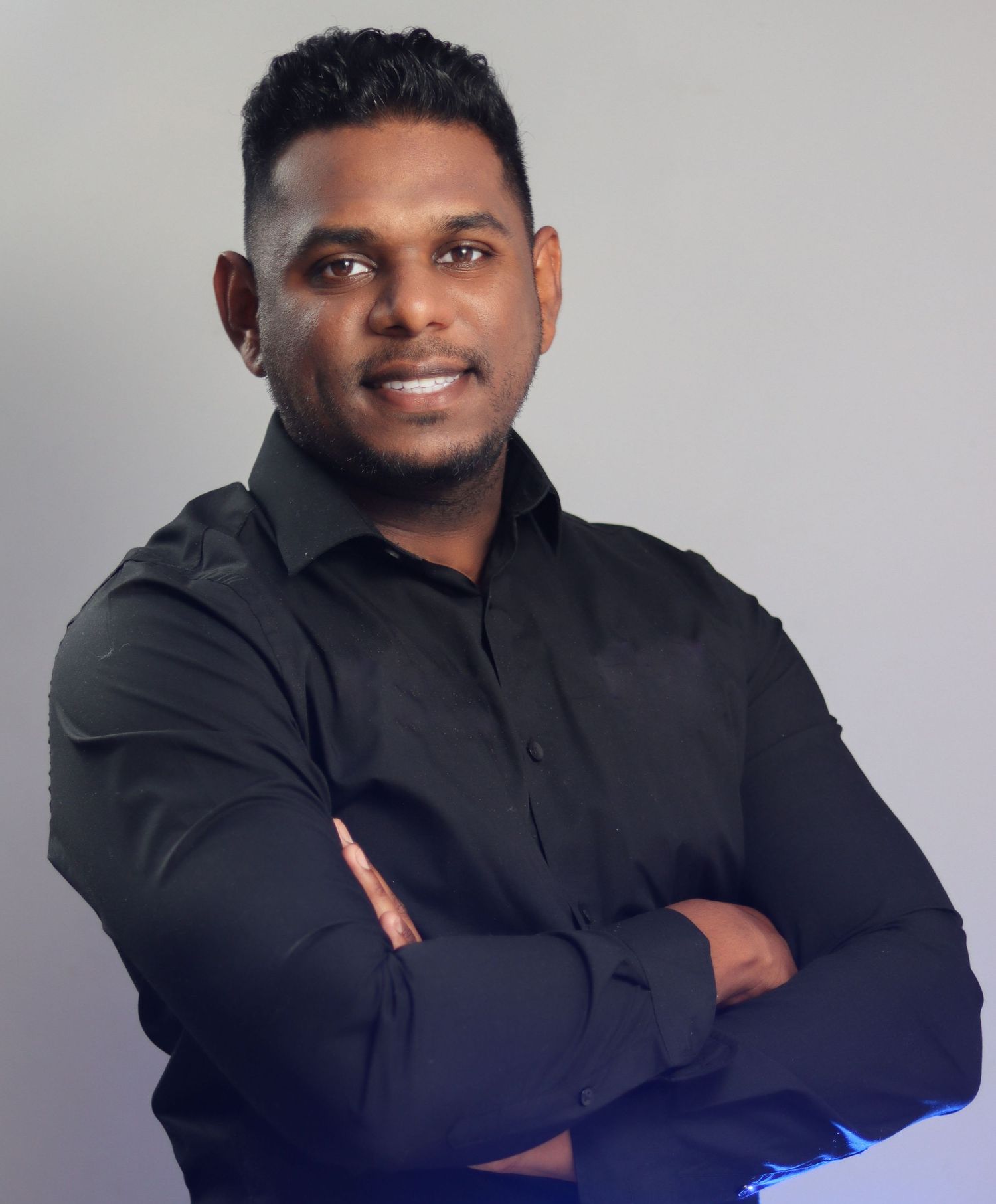 Business professional headshot with confident expression and studio lighting”