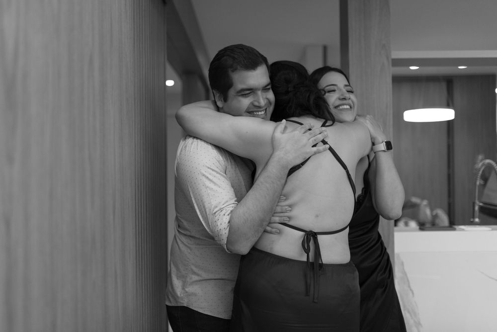 A heartfelt embrace captured in black and white during an emotional moment.