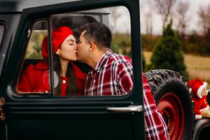 Romantic moment captured through vintage truck window.