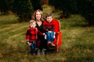 Family portrait on red vintage chair in grassy field.
Janesville, WI
Brodhead, WI