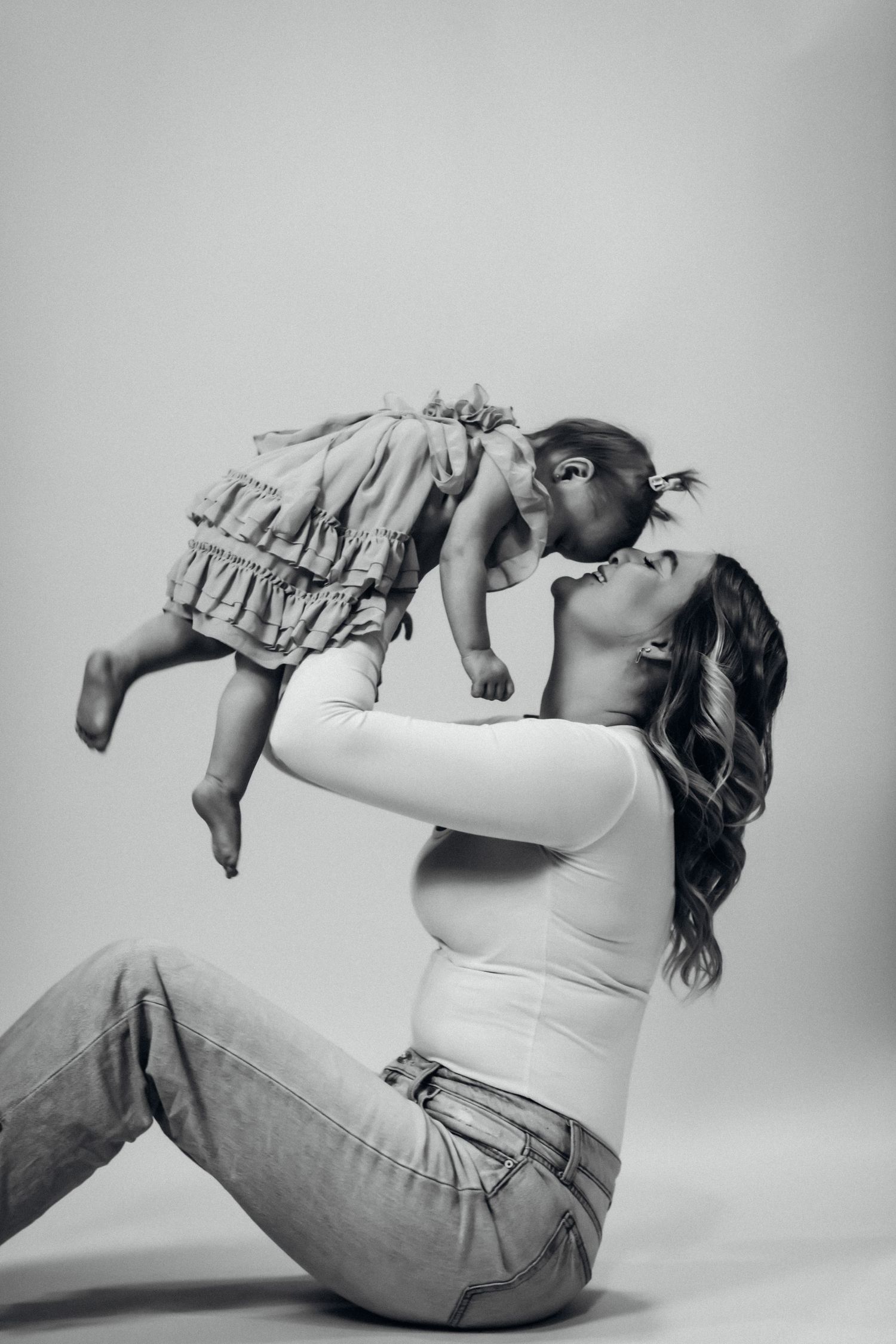 Black and white intimate portrait showing tender family moment.