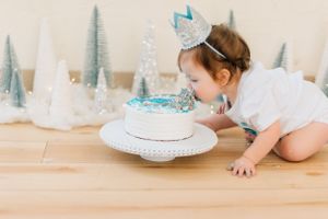Winter themed first birthday setup with blue and silver decorative elements.