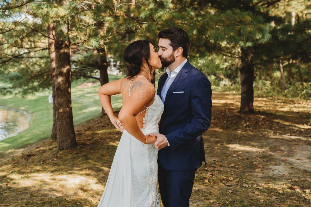 Emotional wedding couple sharing their first look moment in a scenic wooded area.