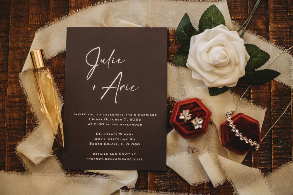 Elegant wedding stationery suite featuring dark gray invitations and white roses.