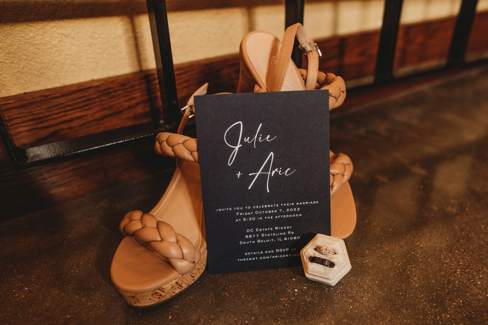 Close-up of wedding signage and decor details in dark tones.