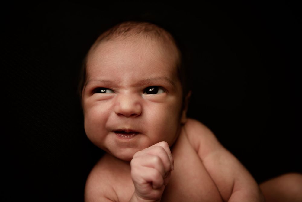 newborn with a grimace expression -Pueblo, Colorado Newborn Photographer
