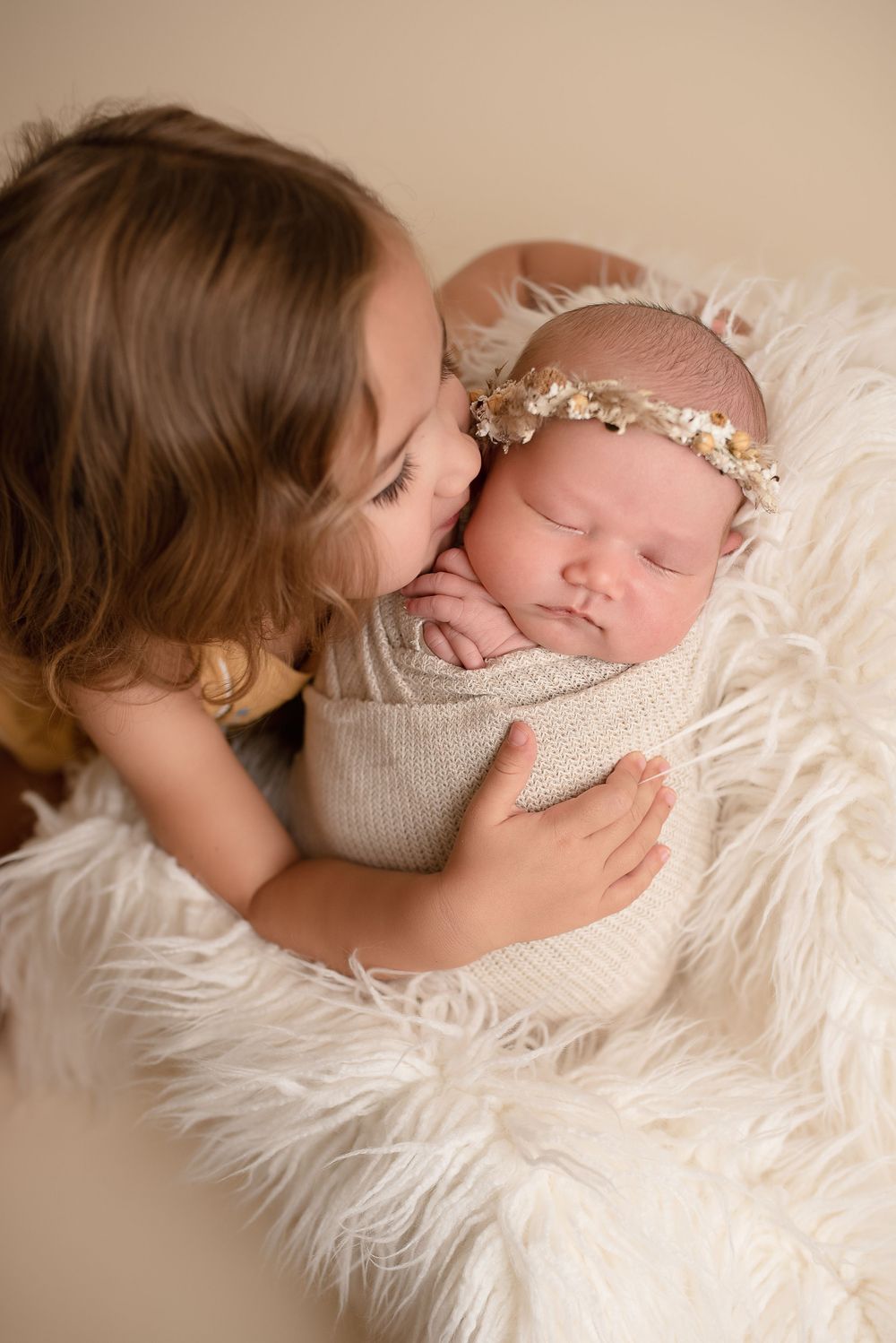 girl kissing newborn sister -Pueblo, Colorado Newborn Photographer